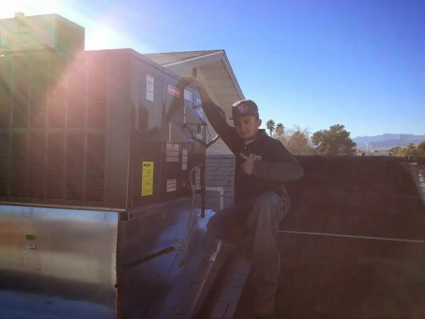 HVAC technician performing Boiler Repair on a rooftop unit in Bothell